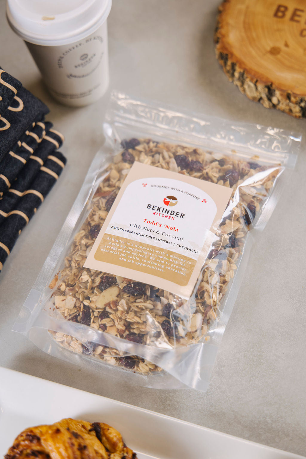 Bekinder granola beside coffee cup